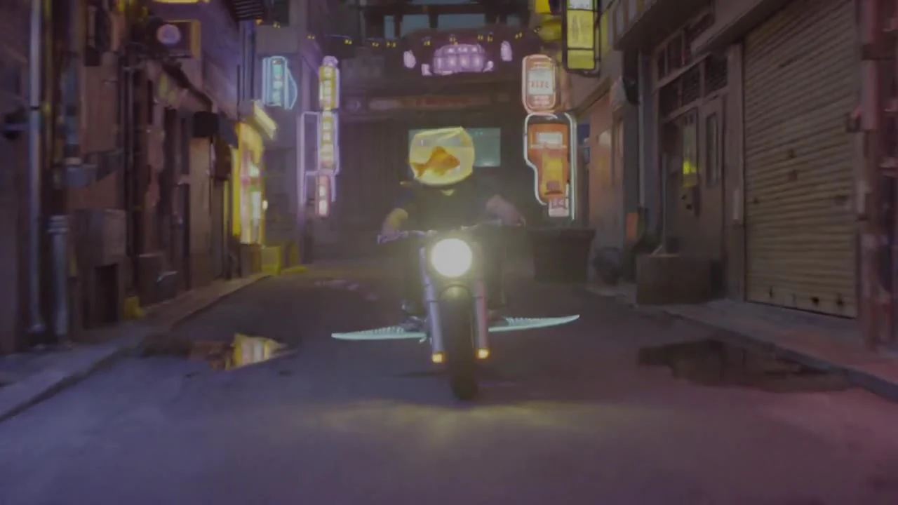 A motorcyclist riding along a city street at night