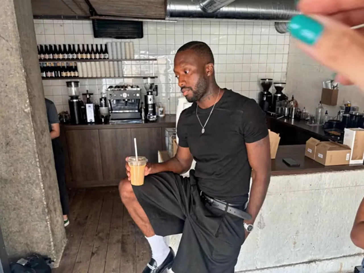 Creative illustration: A man sitting on a kitchen counter holding a drink